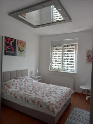 a bedroom with a bed and a window at Apartman Marija in Paraćin