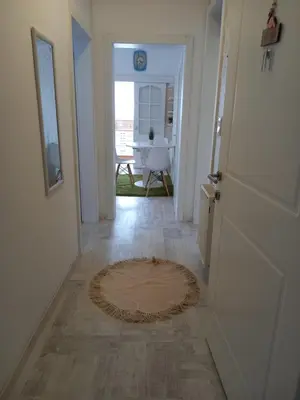 a hallway with a door and a rug on the floor at Apartman Marija in Paraćin