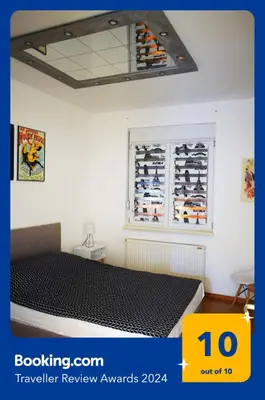 a bedroom with a bed and a window with shoes at Apartman Marija in Paraćin