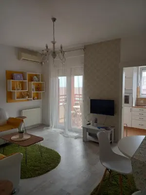a living room with a couch and a tv at Apartman Marija in Paraćin