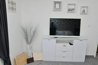 a white entertainment center with a tv on top of it at Apartmani Homoljsko Jutro ☆☆☆☆ Apartments Homolje Morning ☆☆☆☆ in Žagubica