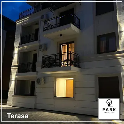 a white building with balconies on the side of it at Apartman Park Promenada in Vrnjačka Banja