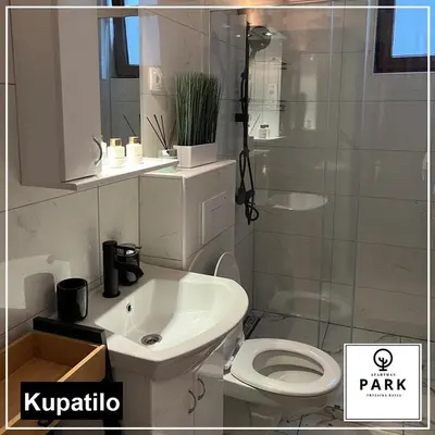 a bathroom with a white toilet and a sink at Apartman Park Promenada in Vrnjačka Banja