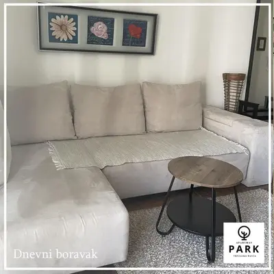 a living room with a couch and a table at Apartman Park Promenada in Vrnjačka Banja