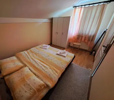 a bedroom with a large bed with two towels on it at Apartman Jova in Vrnjačka Banja