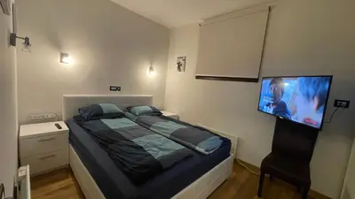 a bedroom with a bed and a flat screen tv at Vila Pahulja - Konoba 1 in Kopaonik