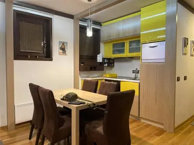 a kitchen with a table and chairs in a room at Vila Pahulja - Konoba 1 in Kopaonik