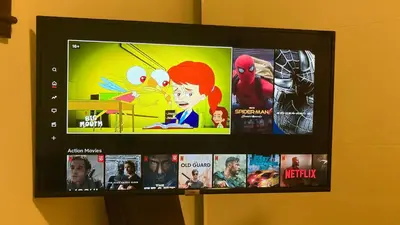 a flat screen tv hanging on a wall with movies at Vila Pahulja - Konoba 1 in Kopaonik