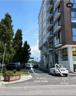 a car parked in a parking lot next to a building at De Lux Nedeljkovic in Jagodina