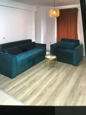 a living room with two blue couches and a table at De Lux Nedeljkovic in Jagodina
