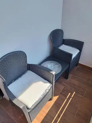 two chairs sitting next to each other in a room at Apartman Andjelika Vrnjacka Banja in Vrnjačka Banja