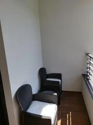two chairs sitting in a corner of a room at Apartman Andjelika Vrnjacka Banja in Vrnjačka Banja