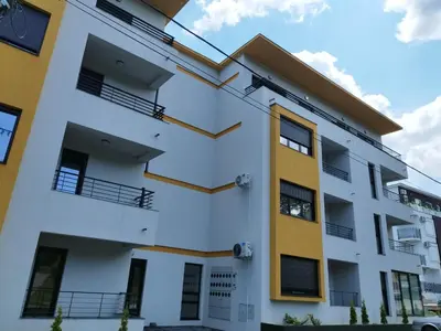 a white building with yellow accents at Apartman Andjelika Vrnjacka Banja in Vrnjačka Banja