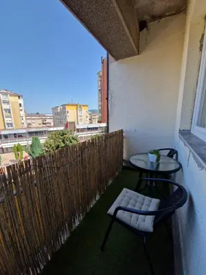 a balcony with a table and chairs and a window at Apartman REA 1 in Pirot