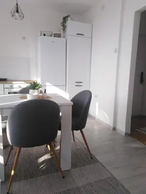 a dining room with a table and two chairs at Apartman REA 1 in Pirot