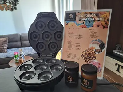 a cookie churning machine sitting on a table with two cups at D&M Porodični apartman in Vrnjačka Banja