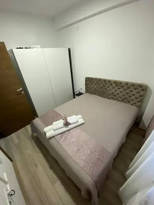 a bedroom with a bed with two towels on it at Aqua Panoramic Apartments in Jagodina
