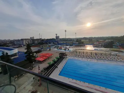 a large swimming pool in a parking lot at Aqua Panoramic Apartments in Jagodina
