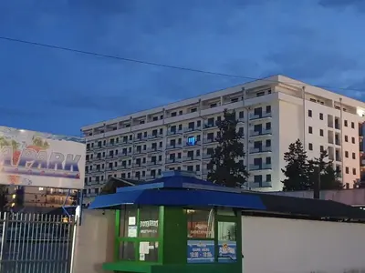 a building with a blue umbrella in front of a building at Aqua Panoramic Apartments in Jagodina