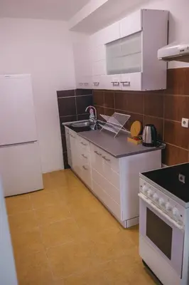 a kitchen with a stove and a white refrigerator at RIVERVIEW in Niš