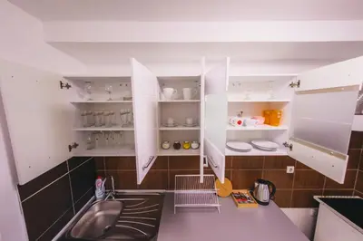 a kitchen with white cabinets and a sink at RIVERVIEW in Niš