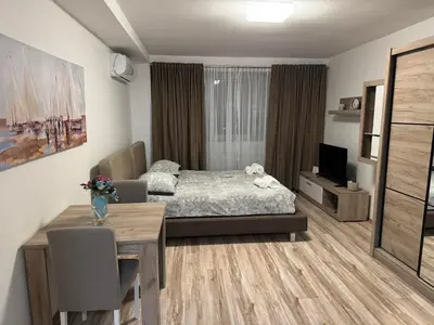 a living room with a bed and a dining table at RIVERVIEW in Niš