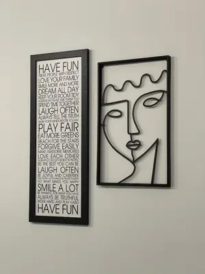 two framed art prints of a face on a wall at Family Home Niš , FREE parking in Niš