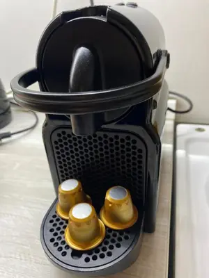 a coffee maker with three golden whistles in it at Family Home Niš , FREE parking in Niš