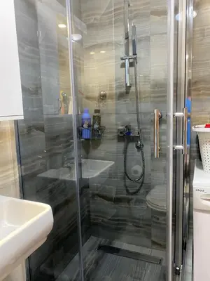 a shower with a glass door in a bathroom at Family Home Niš , FREE parking in Niš