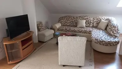 a living room with a couch and a tv at Apartman Saša in Vranje