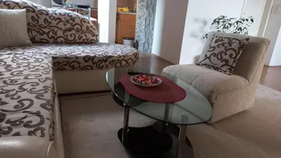 a living room with a couch and a glass table at Apartman Saša in Vranje