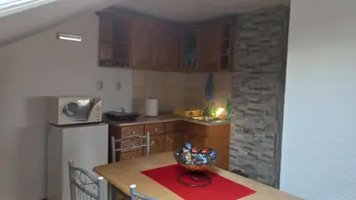 a kitchen with a table with a bowl on it at Apartman Saša in Vranje