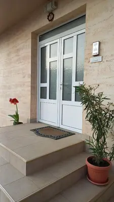 a front door of a house with a potted plant at Apartman Saša in Vranje
