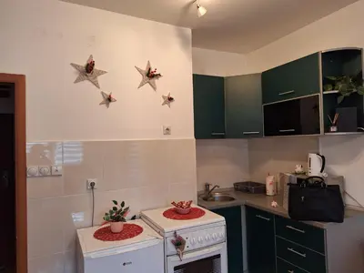 a kitchen with a stove and some stars on the wall at Luka Lux in Niš