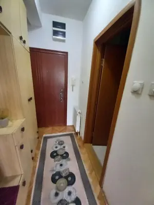 a hallway with a rug on the floor in a room at Luka Lux in Niš