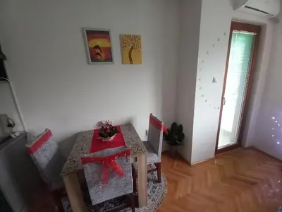 a dining room with a table with a red bow at Luka Lux in Niš