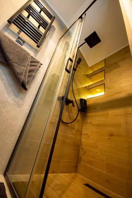 a bathroom with a shower with a glass door at Aqua Casa in Vrnjačka Banja