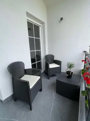 a room with chairs and a table and a window at Aqua Casa in Vrnjačka Banja