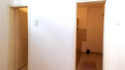 an open door to a hallway in a room at Janković Apartmani u centru in Soko Banja