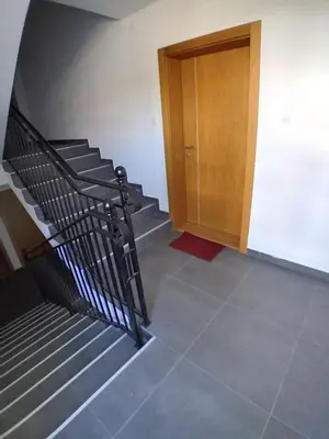 a set of stairs with a wooden door in a building at Vesna M in Soko Banja