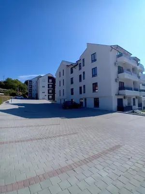 a large parking lot in front of a white building at Vesna M in Soko Banja