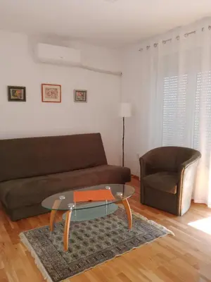a living room with a couch and a glass table at Vesna M in Soko Banja