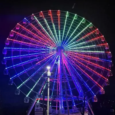 a large ferris wheel with colorful lights on it at Apartman Boba Vrnjačka Banja in Vrnjačka Banja