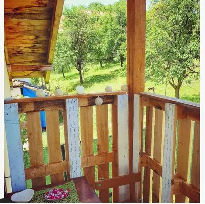 a porch of a cabin with a view of a field at Apartman Boba Vrnjačka Banja in Vrnjačka Banja