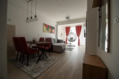 a living room with a table and a couch at Petković apartmani 48 in Jagodina