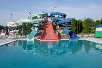a water slide in a swimming pool in a park at Petković apartmani 48 in Jagodina