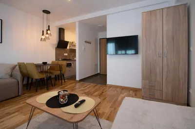 a living room with a couch and a table at Petković apartmani 31 STUDIO in Jagodina