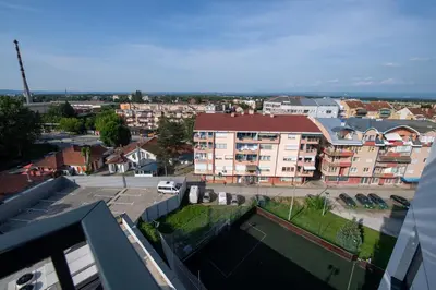 a view of a city with buildings and a parking lot at Petković apartmani 31 STUDIO in Jagodina
