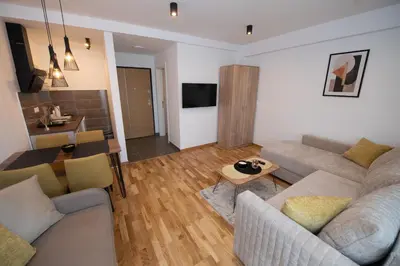a living room with two couches and a table at Petković apartmani 31 STUDIO in Jagodina