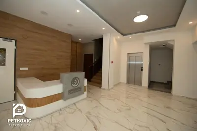 a large room with a bed and a hallway at Petković apartmani 34 in Jagodina